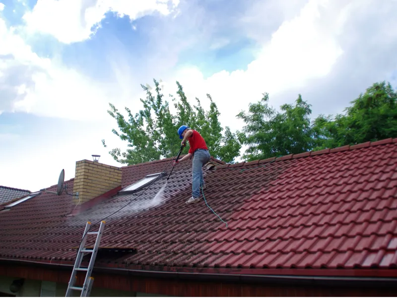 Professional high-pressure roof cleaning in progress on Gold Coast tiled roof