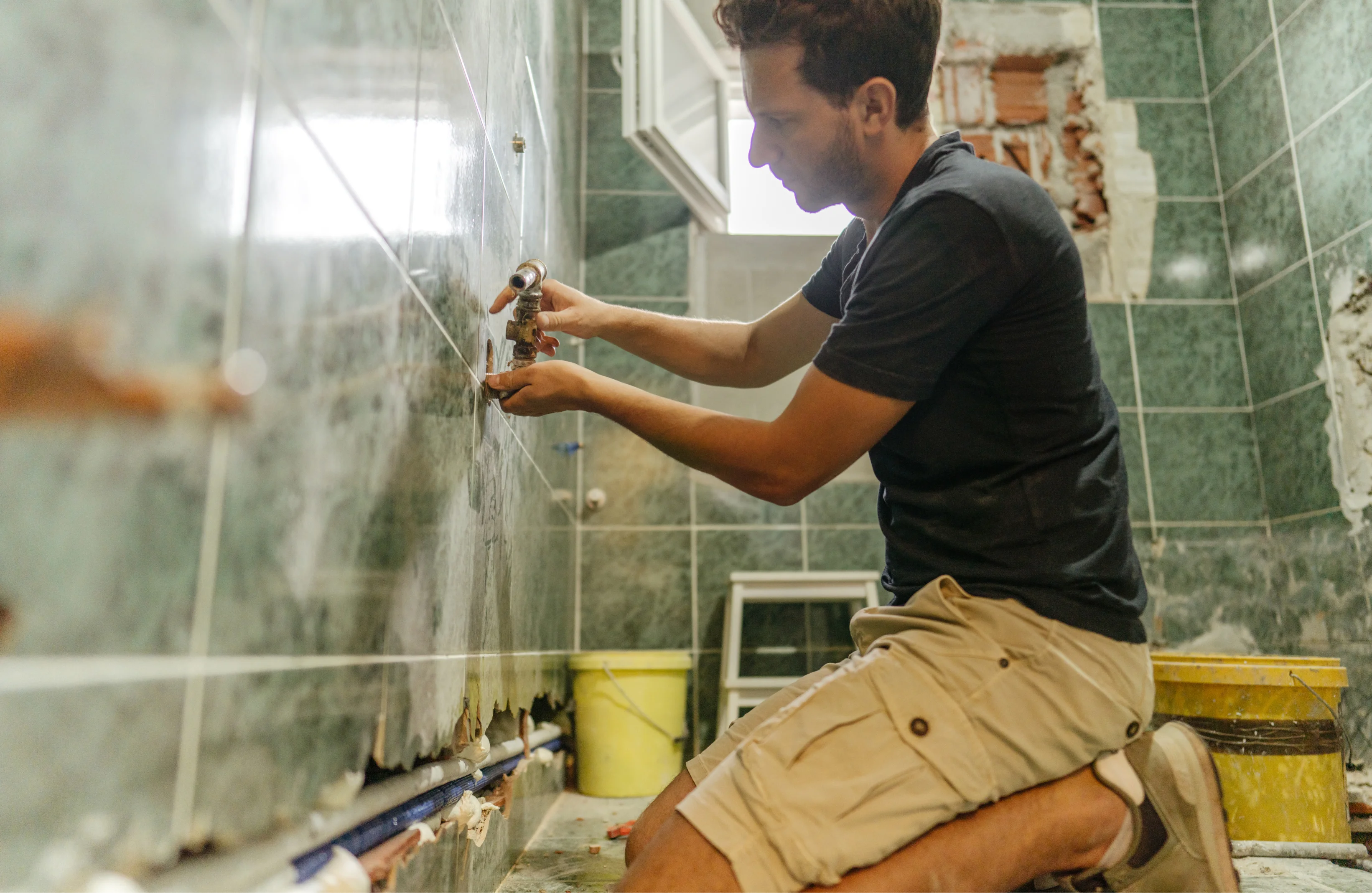 Professional bathroom renovation in Perth showing plumbing installation, tile removal, and waterproofing work by licensed tradespeople