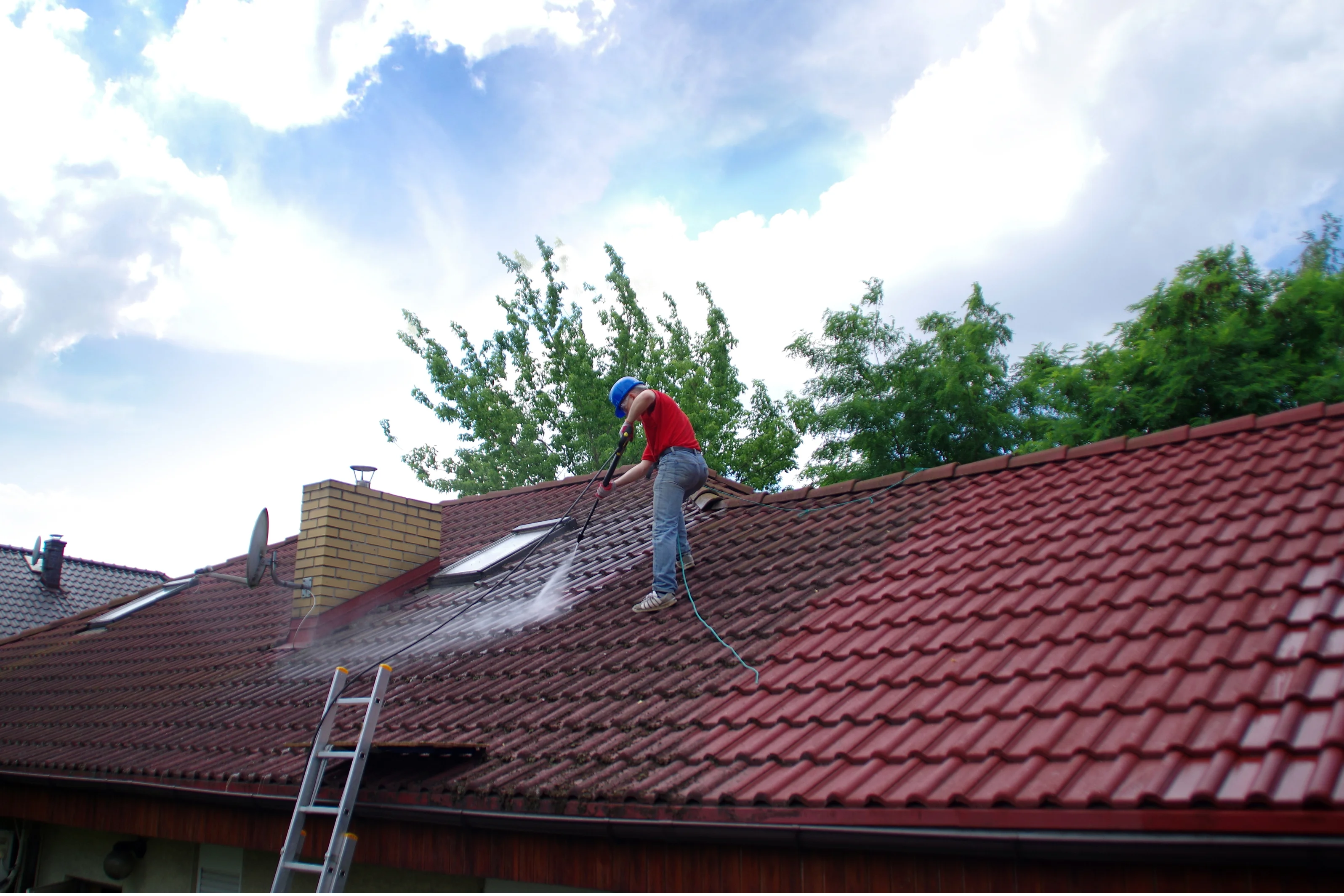 Professional high-pressure roof cleaning in progress on Newcastle tiled roof